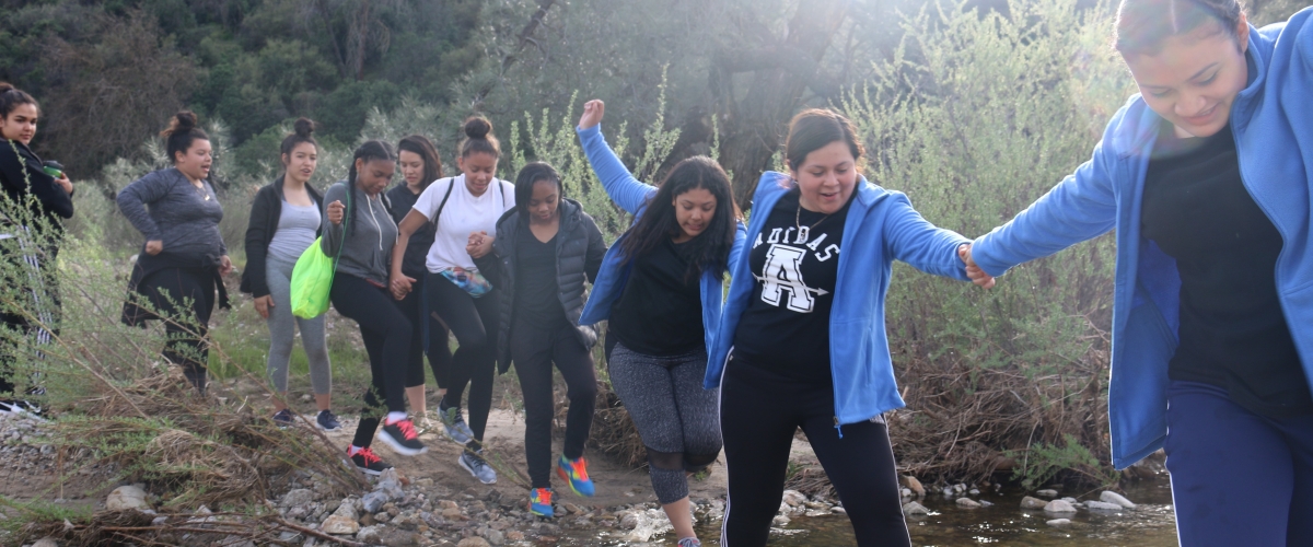 Kids crossing a stream